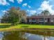 Building with pond view and lush landscaping at 236 Caryl Way # 16, Oldsmar, FL 34677