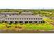 Aerial view of townhouses with water features and landscaping at 3632 Bellmeade Ct, Wesley Chapel, FL 33543