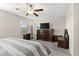 Bright bedroom featuring a comfortable bed, built-in shelving, and a ceiling fan at 3632 Bellmeade Ct, Wesley Chapel, FL 33543