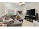 Living room with sectional sofa, large TV, and view of kitchen at 3632 Bellmeade Ct, Wesley Chapel, FL 33543