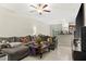 Living room with sectional sofa, large TV, and view of kitchen at 3632 Bellmeade Ct, Wesley Chapel, FL 33543