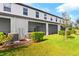 Townhouse exterior with screened patio and manicured lawn at 3632 Bellmeade Ct, Wesley Chapel, FL 33543