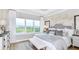 Spacious main bedroom with large windows, plush bed, and tranquil views at 748 Steel Dr, Apollo Beach, FL 33572