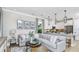 Open living room with L-shaped sofa and kitchen views at 748 Steel Dr, Apollo Beach, FL 33572