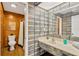 Bathroom with shower, toilet, and unique tile design at 8014 Peach Dr, Temple Terrace, FL 33637
