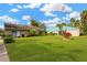 Community clubhouse with green lawn and American flag at 8014 Peach Dr, Temple Terrace, FL 33637