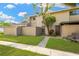 Tan townhouse with a small front yard at 8014 Peach Dr, Temple Terrace, FL 33637