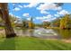 Serene pond with fountain, surrounded by trees and landscaping at 8014 Peach Dr, Temple Terrace, FL 33637