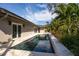 Inviting pool with stone coping, surrounded by tropical landscaping at 861 Rafael Ne Blvd, St Petersburg, FL 33704