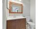 Bathroom with wood vanity, white toilet and mirror at 901 Normandy Trace Rd, Tampa, FL 33602