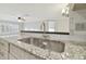 Modern kitchen with granite countertops, a double sink, and a stylish faucet at 901 Normandy Trace Rd, Tampa, FL 33602