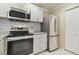 Updated kitchen featuring stainless steel appliances and white shaker cabinets at 901 Normandy Trace Rd, Tampa, FL 33602