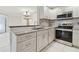 Modern kitchen with updated cabinetry, granite countertops, and stainless steel appliances at 901 Normandy Trace Rd, Tampa, FL 33602