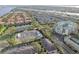 Aerial view of community, featuring multiple buildings, landscaping, and waterways at 901 Normandy Trace Rd, Tampa, FL 33602