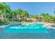 Community pool with lounge chairs and palm trees at 901 Normandy Trace Rd, Tampa, FL 33602