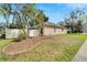 Landscaped backyard with a fenced perimeter and mature trees at 12611 River Birch Dr, Riverview, FL 33569