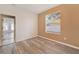 Bedroom with wood flooring and large window at 12611 River Birch Dr, Riverview, FL 33569