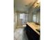 Guest bathroom with dark vanity and shower/tub combo at 1404 Woodstream Dr, Oldsmar, FL 34677