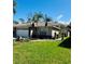 Single-story home with attached garage and palm trees at 1404 Woodstream Dr, Oldsmar, FL 34677