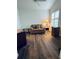 Home office with wood-look flooring and a comfy loveseat at 1404 Woodstream Dr, Oldsmar, FL 34677