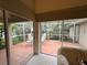 View of a relaxing screened patio with seating from the interior at 1404 Woodstream Dr, Oldsmar, FL 34677