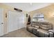 Bedroom with gray reclining sofa, double doors, and a large window at 1414 Monte Lake Dr, Valrico, FL 33596