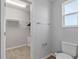 Bathroom with toilet, shower, and walk-in closet at 16120 59Th E Ct, Parrish, FL 34219