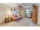 Bedroom with pink futon, ceiling fan, and ample closet space at 1900 59Th N Ave # 305, St Petersburg, FL 33714