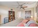 Bedroom with pink futon, built-in shelving, and access to bathroom at 1900 59Th N Ave # 305, St Petersburg, FL 33714