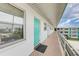 A hallway with teal doors and light-colored flooring, offering a view of other apartments at 1900 59Th N Ave # 305, St Petersburg, FL 33714