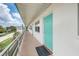 Building hallway with teal door and balcony access at 1900 59Th N Ave # 305, St Petersburg, FL 33714