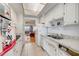 Open kitchen with white cabinets, double sink, and views to living area at 1900 59Th N Ave # 305, St Petersburg, FL 33714