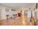 Living room with hardwood floors, featuring a sofa, TV, and access to the kitchen at 1900 59Th N Ave # 305, St Petersburg, FL 33714