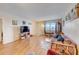 Living room with hardwood floors, featuring a sofa, window and access to the balcony at 1900 59Th N Ave # 305, St Petersburg, FL 33714