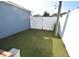 Enclosed backyard featuring an artificial grass lawn and white vinyl fencing at 2918 10Th N St, St Petersburg, FL 33704