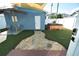Charming backyard with artificial turf, a stone walkway, hot tub, and cozy patio at 2918 10Th N St, St Petersburg, FL 33704
