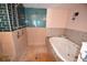 Bathroom features a walk-in shower with blue tiles and a soaking tub with mosaic tile accents at 2918 10Th N St, St Petersburg, FL 33704