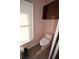 A powder room featuring wood-look tile floor, toilet, and an upper cabinet at 2918 10Th N St, St Petersburg, FL 33704