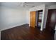 Bedroom with dark brown laminate wood flooring and sliding door closet at 2918 10Th N St, St Petersburg, FL 33704