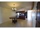 Open dining area with chandelier and dark wood kitchen in the background at 2918 10Th N St, St Petersburg, FL 33704