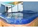 Relaxing backyard hot tub featuring a blue marbled shell and wood surround at 2918 10Th N St, St Petersburg, FL 33704