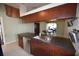 A kitchen with a stainless steel sink, dishwasher and dark wood cabinets at 2918 10Th N St, St Petersburg, FL 33704