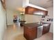Bright kitchen with wooden cabinets, modern appliances, and neutral tile flooring adjoining dining area at 2918 10Th N St, St Petersburg, FL 33704