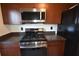 Stainless steel oven, microwave and black refrigerator in this kitchen with brown cabinets at 2918 10Th N St, St Petersburg, FL 33704