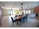 Open concept living area featuring a modern dining set, a fireplace, and plenty of natural light from large windows at 2918 10Th N St, St Petersburg, FL 33704