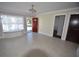 Bright living room with tiled floors, a bay window seat, and an open entrance with a red door at 2918 10Th N St, St Petersburg, FL 33704