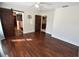 Spacious main bedroom with dark brown wood floors and barn door to en-suite at 2918 10Th N St, St Petersburg, FL 33704