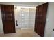 Walk-in pantry behind wooden doors with custom organizers at 2918 10Th N St, St Petersburg, FL 33704