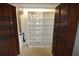 Storage area with white shelving and dark wood bi-fold doors at 2918 10Th N St, St Petersburg, FL 33704