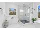 Bright bathroom featuring a standalone tub, glass shower enclosure and large window at 3317 W Napoleon Ave, Tampa, FL 33611